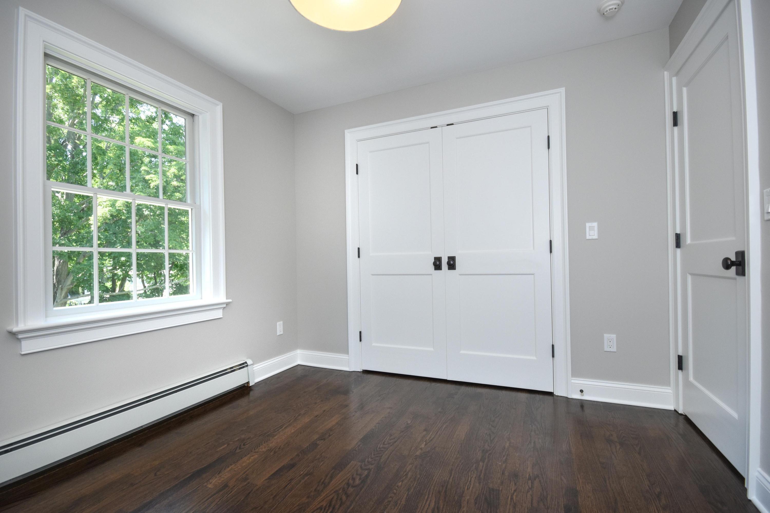 29 Brookside Road Darien, CT 06820 - Photo 18 of 26 a view of an empty room with wooden floor and a window