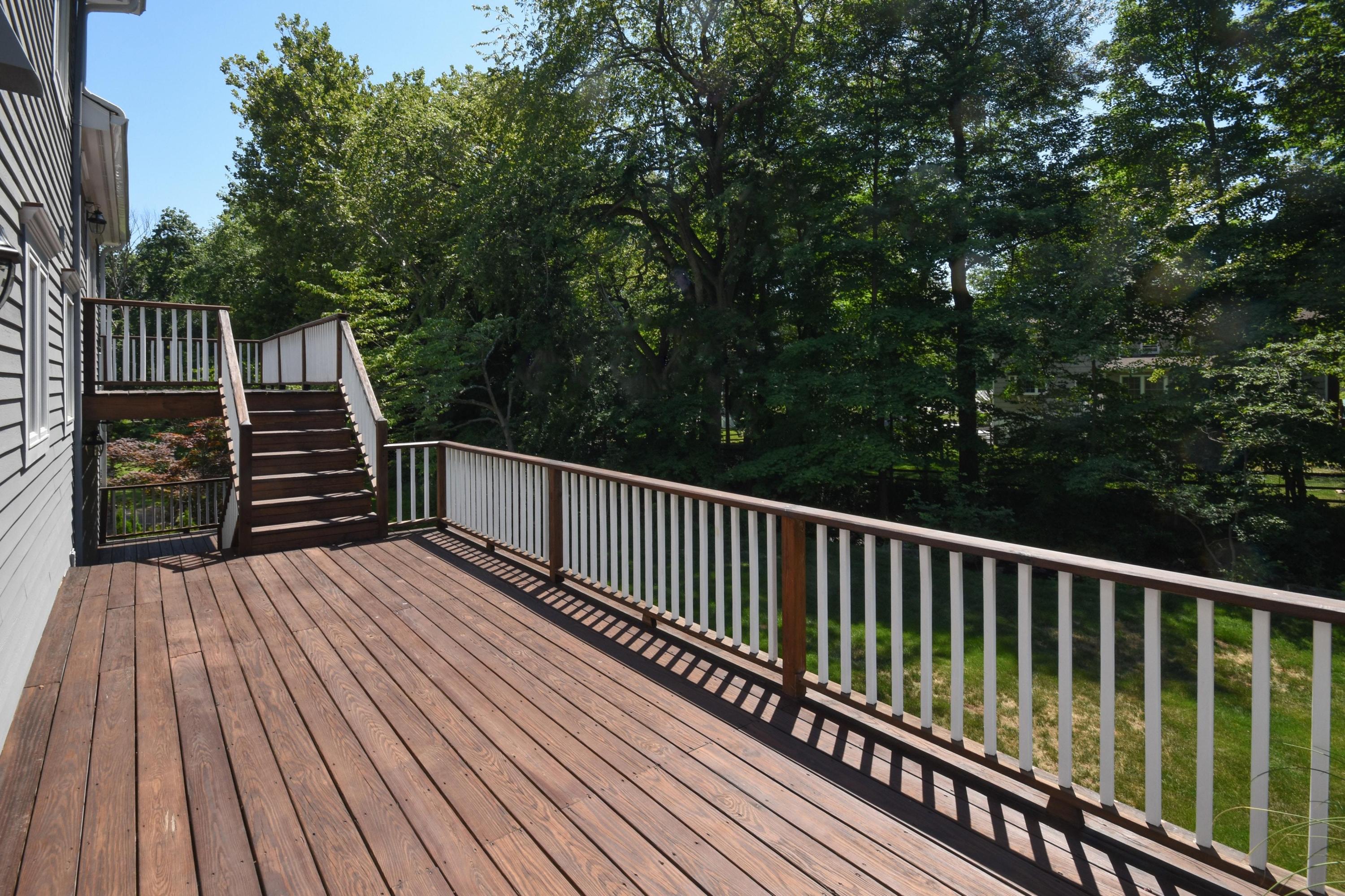 29 Brookside Road Darien, CT 06820 - Photo 21 of 26 a balcony with wooden floor and trees in the back