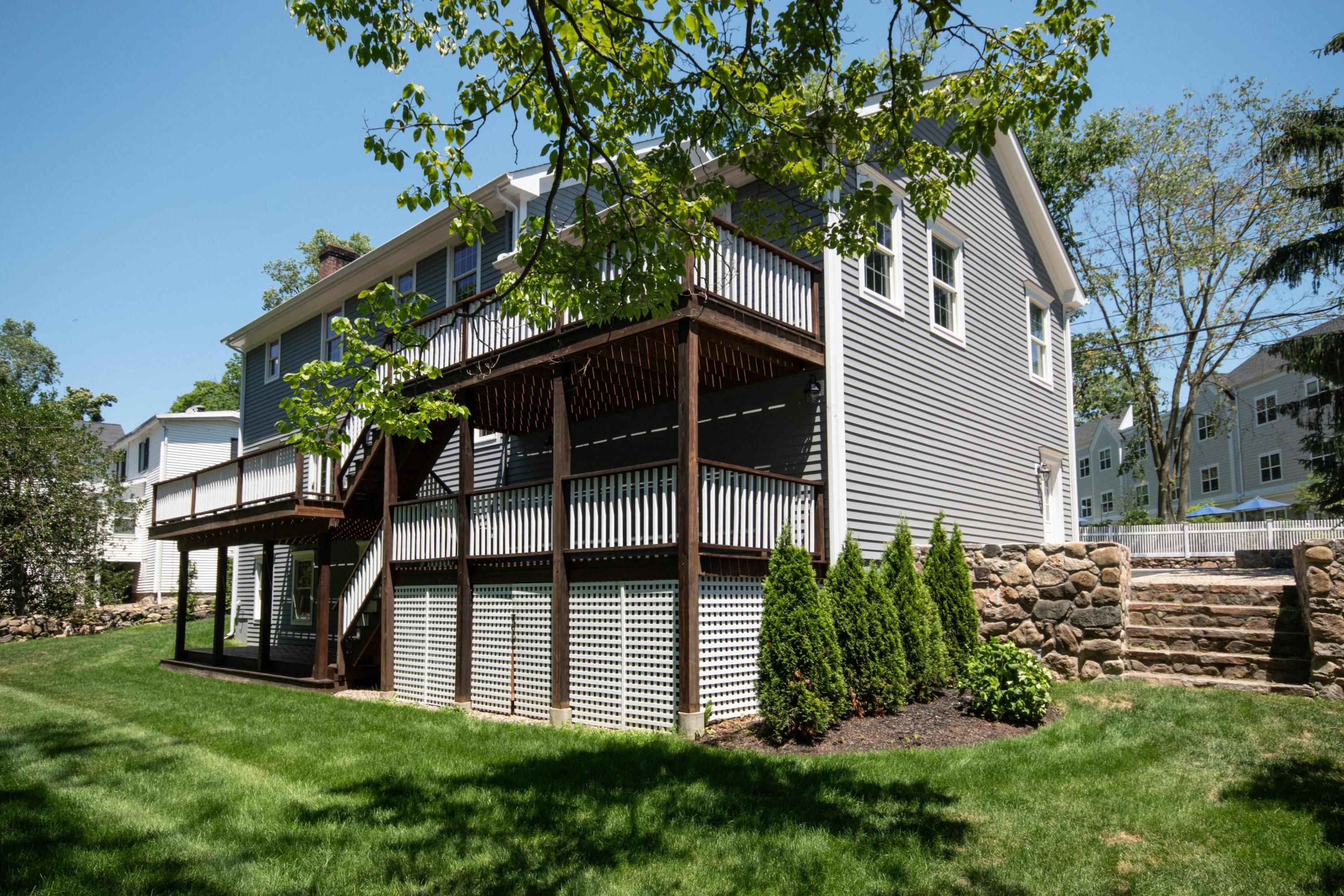 29 Brookside Road Darien, CT 06820 - Photo 23 of 26 a view of front of house with a yard