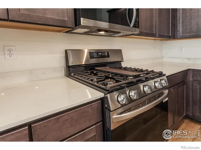 a kitchen with wooden cabinets and a stove top oven