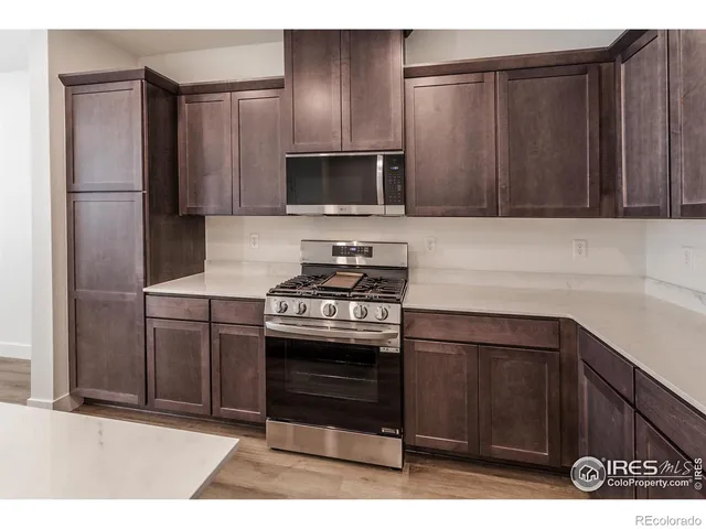 a kitchen with stainless steel appliances wooden cabinets and stove