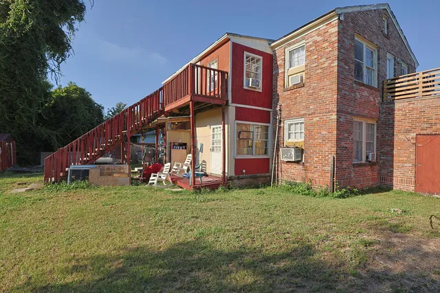 a view of a house with a yard and deck