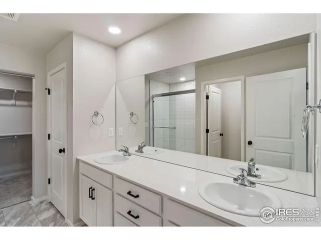 a bathroom with a sink double vanity and a mirror