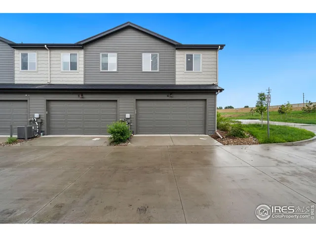 a view of a house with a yard and garage