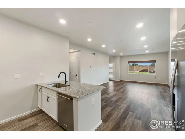 a kitchen with a sink and a refrigerator