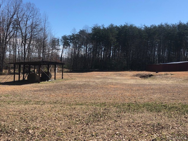 356 Wickham Road Bumpass, VA 23024 - Photo 3 of 15 a street view covered with tall trees