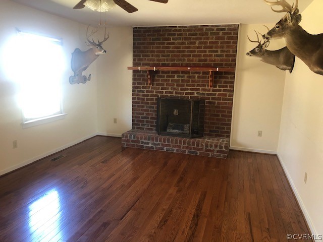 356 Wickham Road Bumpass, VA 23024 - Photo 5 of 15 a view of a livingroom with wooden floor and a fireplace