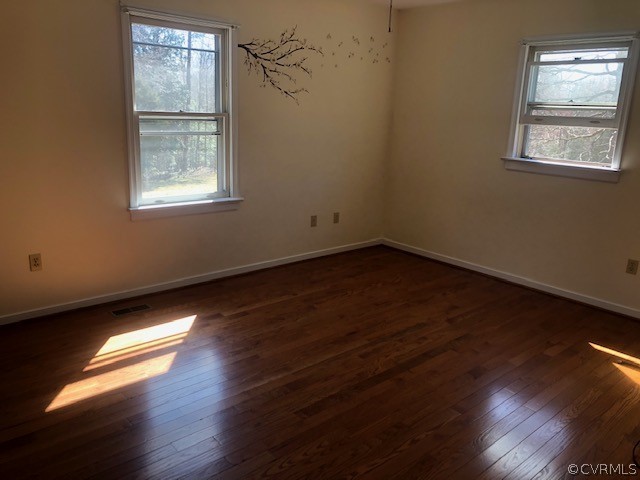 356 Wickham Road Bumpass, VA 23024 - Photo 7 of 15 an empty room with wooden floor and windows