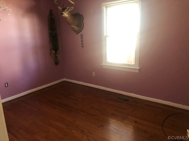 356 Wickham Road Bumpass, VA 23024 - Photo 8 of 15 an empty room with wooden floor and windows