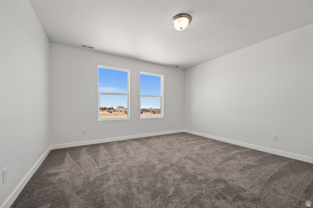 1554 Pheasant Road Eagle Mountain, UT 84005 - Photo 20 of 29 Unfurnished room featuring baseboards and dark carpet