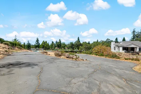 an aerial view of residential house with yard