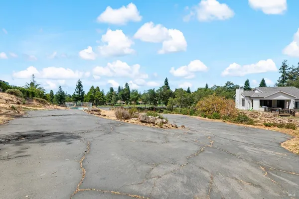 an aerial view of residential house with yard