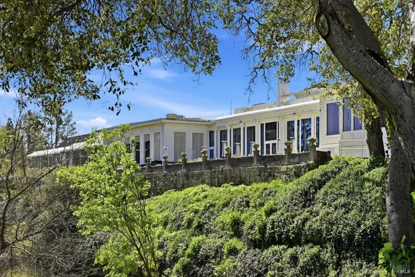 a dining room with furniture and a chandelier