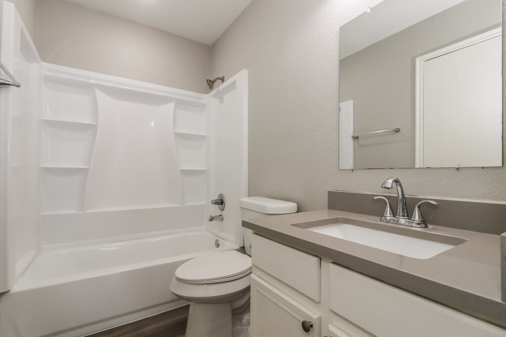 20622 Bishops Gate Lane Humble, TX 77338 - Photo 12 of 17 a bathroom with a sink a toilet and a bathtub