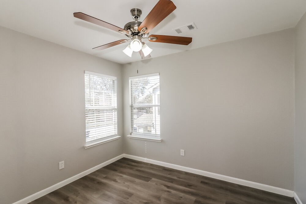 20622 Bishops Gate Lane Humble, TX 77338 - Photo 15 of 17 an empty room with windows and fan