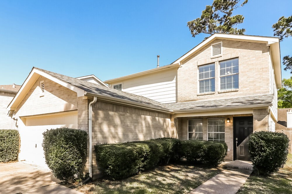 20622 Bishops Gate Lane Humble, TX 77338 - Photo 4 of 17 a front view of a house with garden