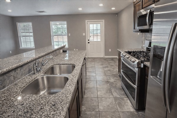 2518 Staples Street Houston, TX 77026 - Photo 2 of 22 a kitchen with a sink stove and microwave