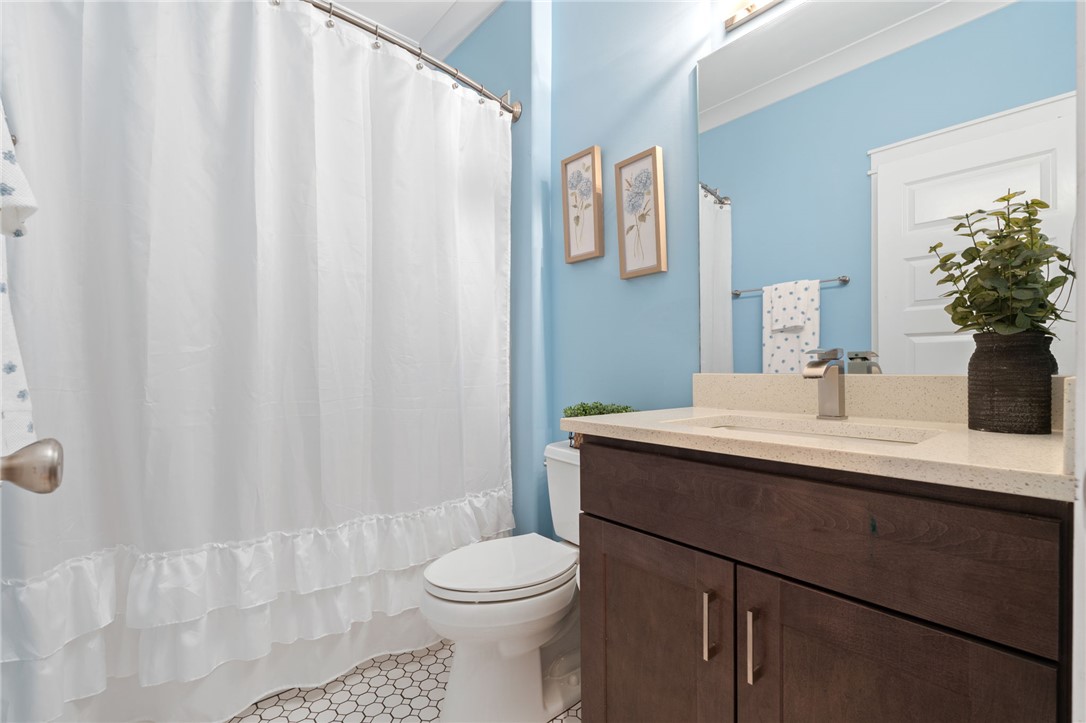 1050 Old Dacusville Road Easley, SC 29640 - Photo 23 of 33 This bathroom features a contemporary vanity with a sleek sink and a classic tiled floor.