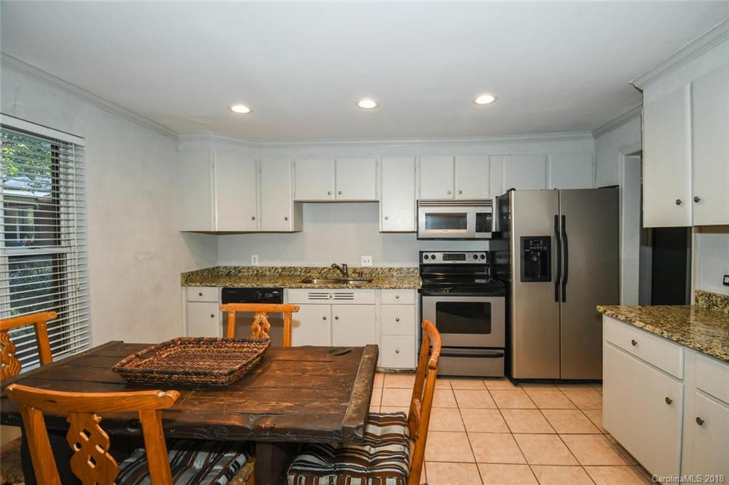 2408 Providence Road, Unit 6 Charlotte, NC 28211 - Photo 11 of 20 a kitchen with granite countertop a stove sink and refrigerator