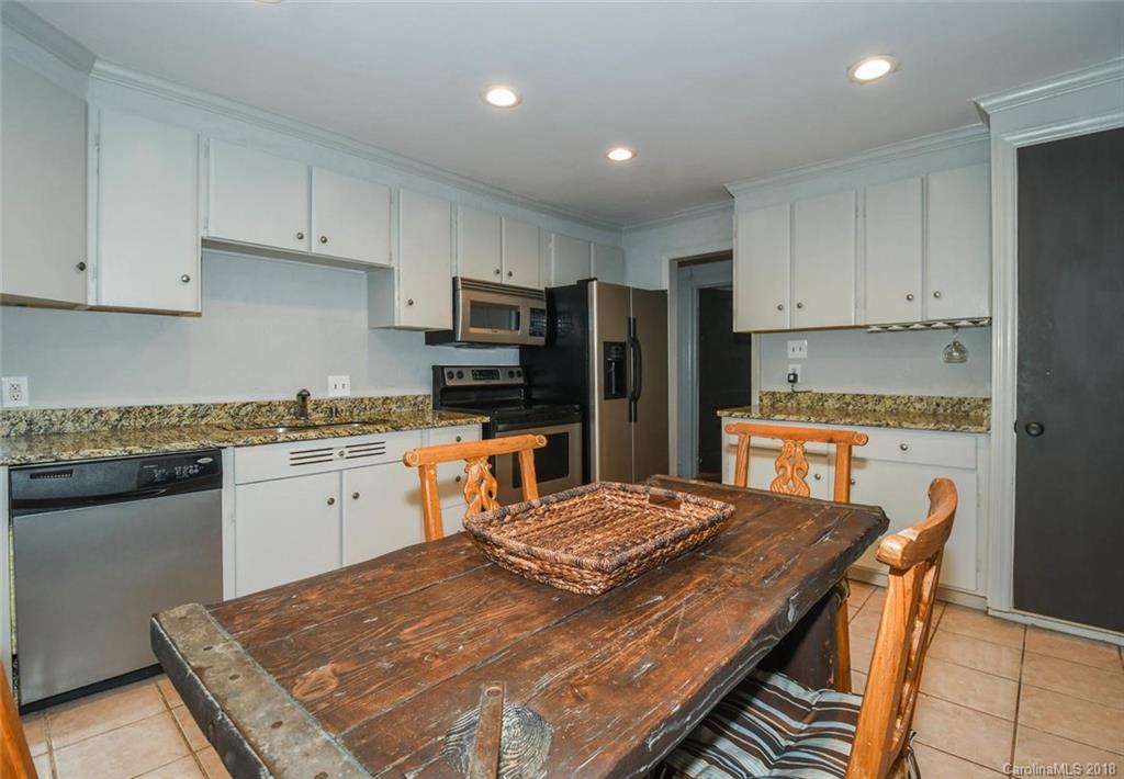 2408 Providence Road, Unit 6 Charlotte, NC 28211 - Photo 13 of 20 a kitchen with a stove a sink a refrigerator and cabinets