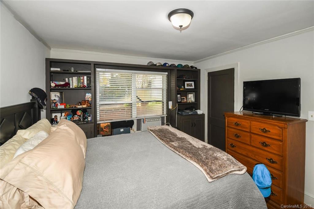 2408 Providence Road, Unit 6 Charlotte, NC 28211 - Photo 15 of 20 a bedroom with a bed and a flat tv screen on dresser