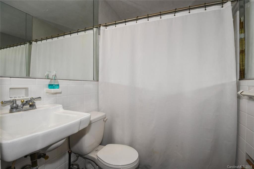 2408 Providence Road, Unit 6 Charlotte, NC 28211 - Photo 18 of 20 a bathroom with a sink mirror and toilet