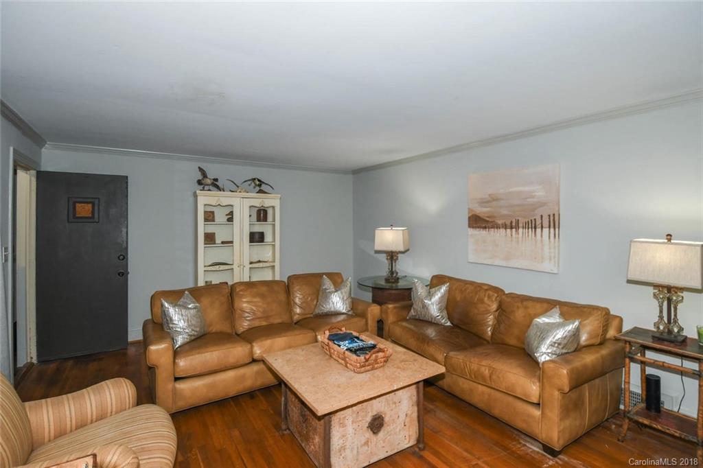2408 Providence Road, Unit 6 Charlotte, NC 28211 - Photo 9 of 20 a living room with furniture a rug and a lamp