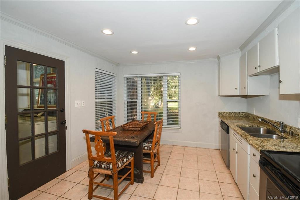 2408 Providence Road, Unit 6 Charlotte, NC 28211 - Photo 10 of 20 a kitchen with stainless steel appliances granite countertop a stove a sink a microwave and a refrigerator
