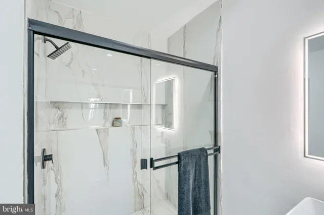 a bathroom with a shower and a glass door