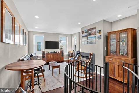 a view of a livingroom with furniture window and wooden floor