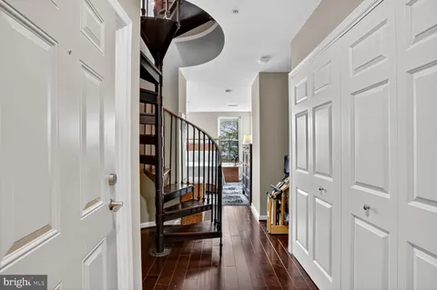 a bedroom with a large bed and a flat tv screen on dresser