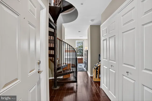 a bedroom with a large bed and a flat tv screen on dresser