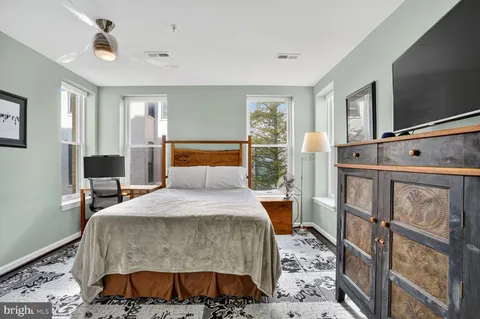 a bedroom with a bed and wooden floor