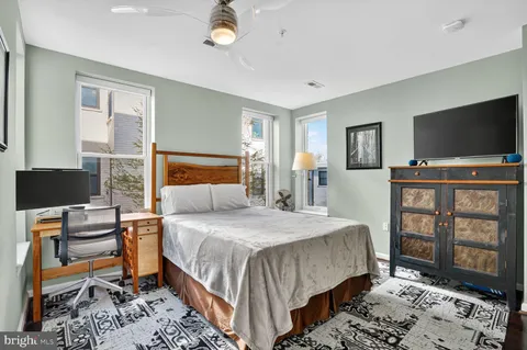 a bedroom with a bed and a flat screen tv