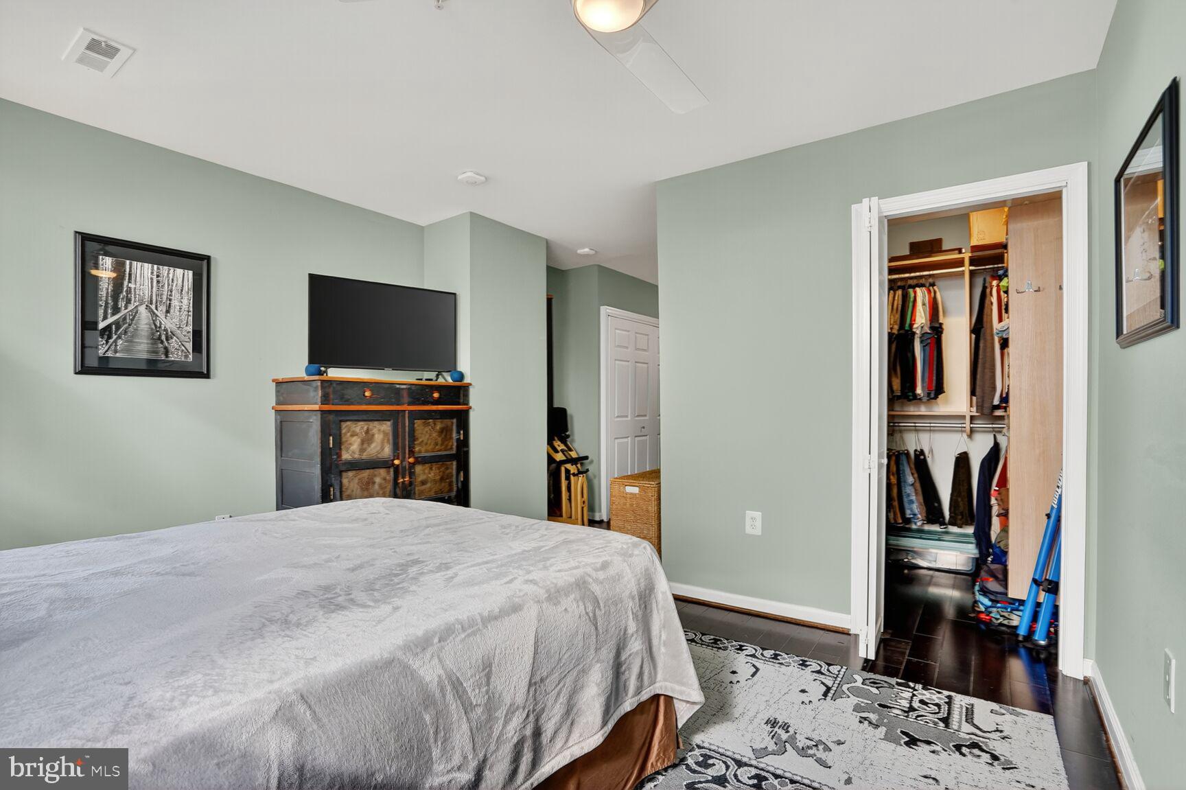 2627 Adams Mill Road Northwest, Unit 403 Washington, DC 20009 - Photo 20 of 38 a bedroom with a bed and a flat screen tv