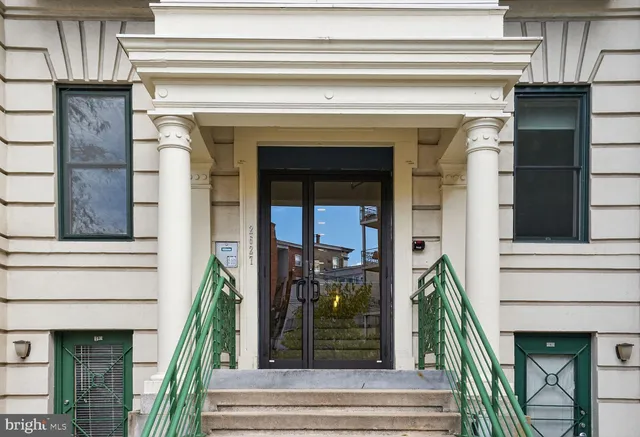 a front view of a house with a potted plant