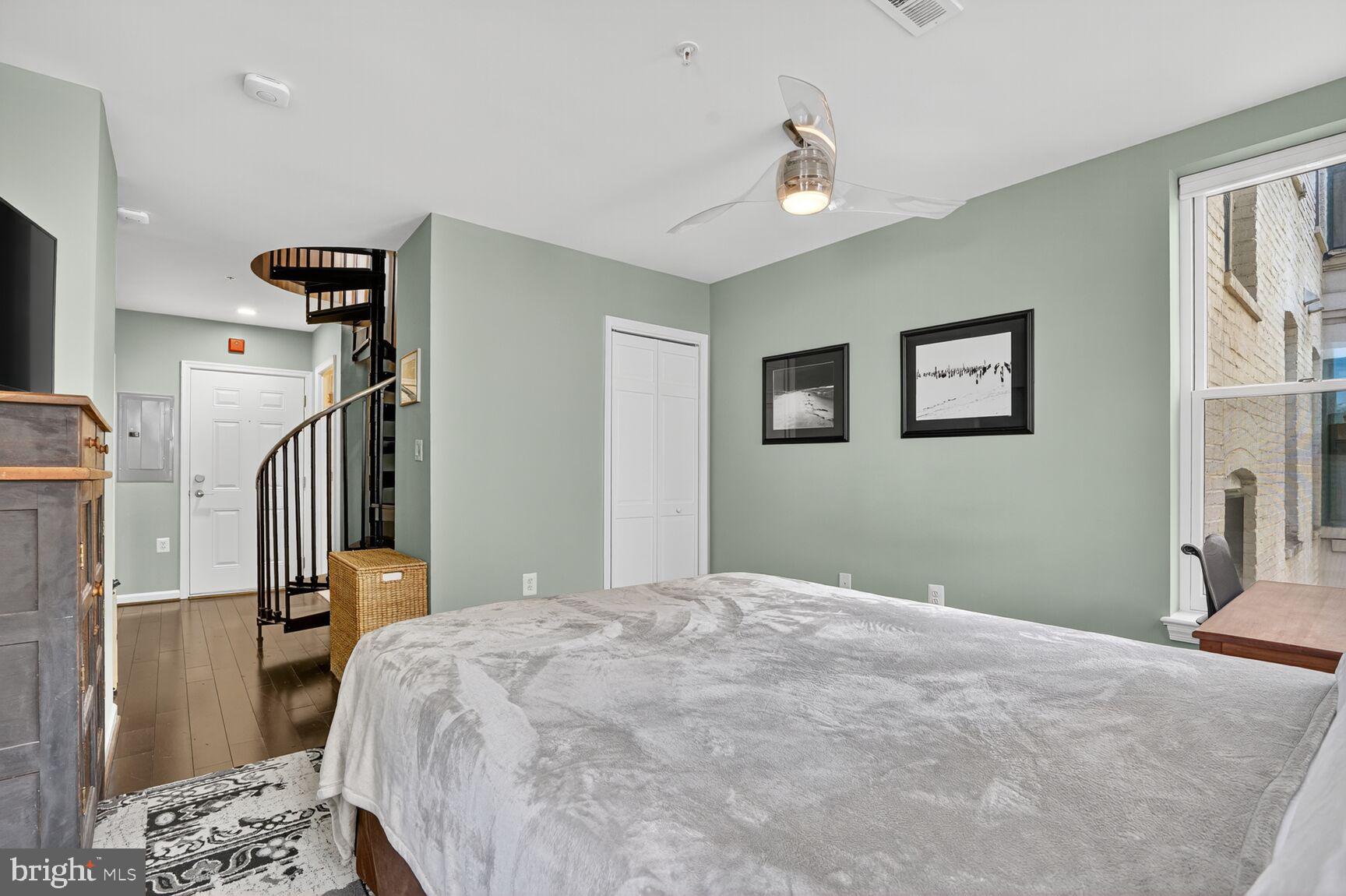 2627 Adams Mill Road Northwest, Unit 403 Washington, DC 20009 - Photo 21 of 38 a bedroom with a bed and a chandelier