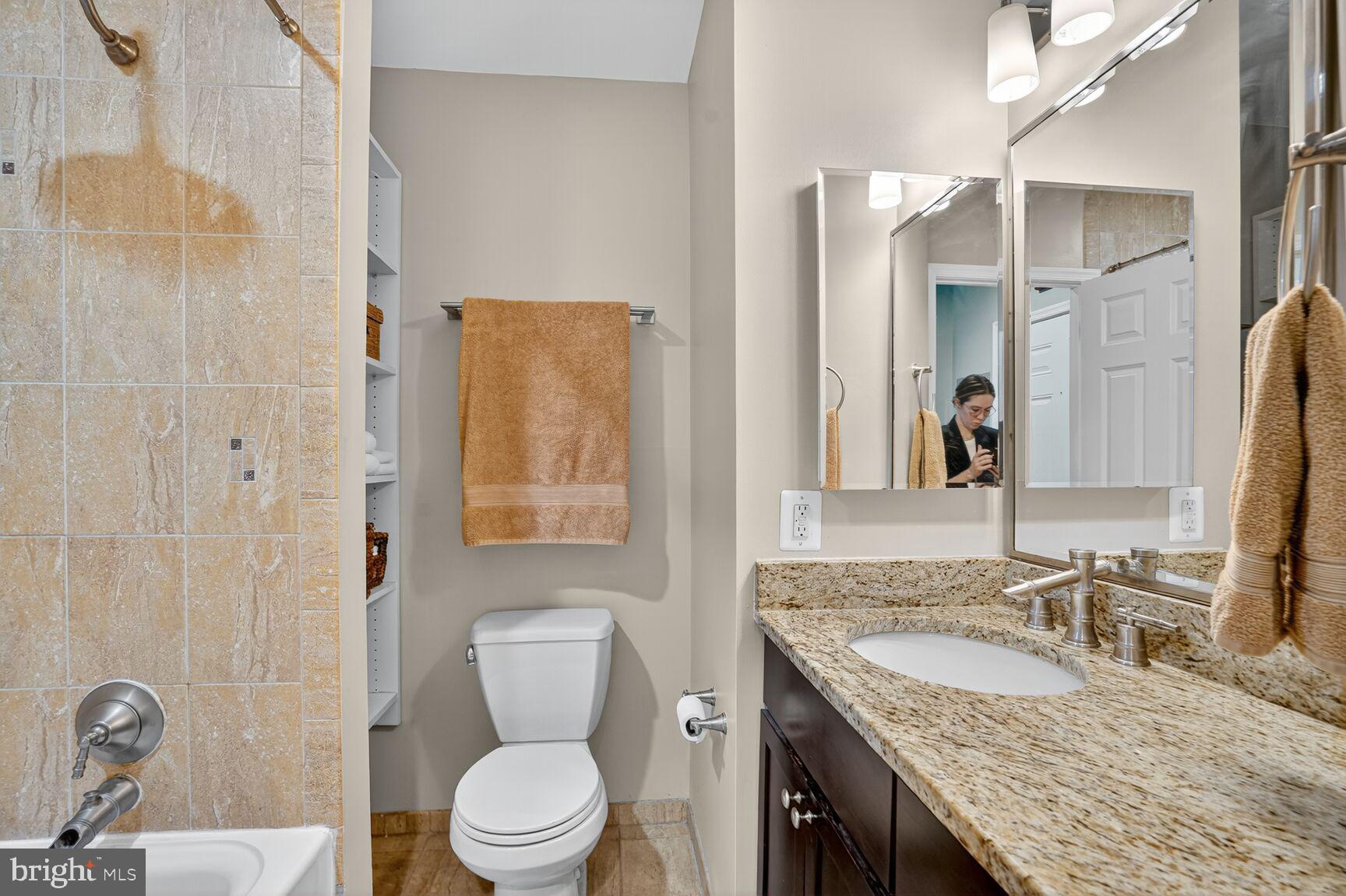 2627 Adams Mill Road Northwest, Unit 403 Washington, DC 20009 - Photo 26 of 38 a bathroom with a granite countertop sink toilet and shower