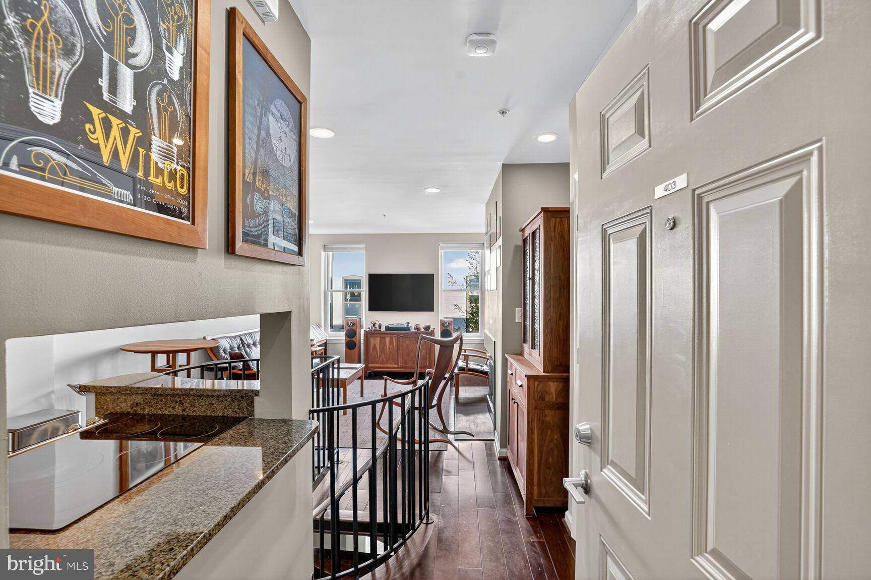 2627 Adams Mill Road Northwest, Unit 403 Washington, DC 20009 - Photo 3 of 38 a view of a livingroom with furniture and a flat screen tv