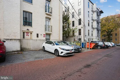 a car parked in front of a white house