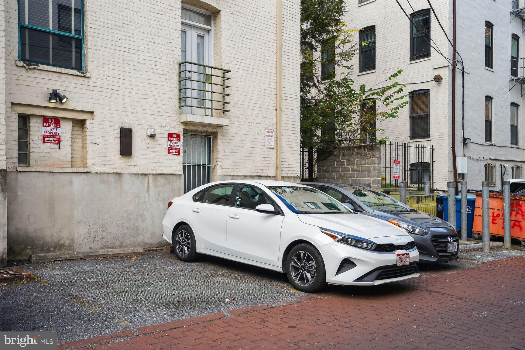 2627 Adams Mill Road Northwest, Unit 403 Washington, DC 20009 - Photo 34 of 38 a car parked in front of a white house