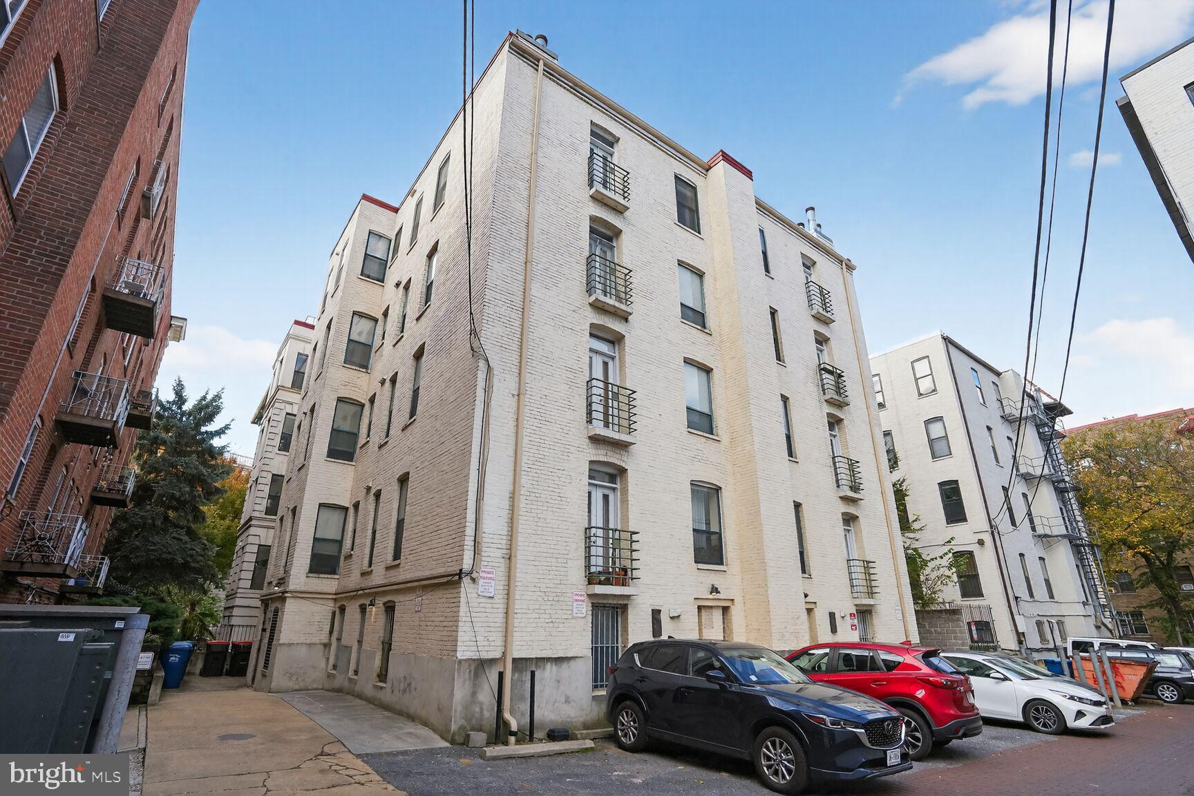 2627 Adams Mill Road Northwest, Unit 403 Washington, DC 20009 - Photo 35 of 38 a city street lined with buildings and cars
