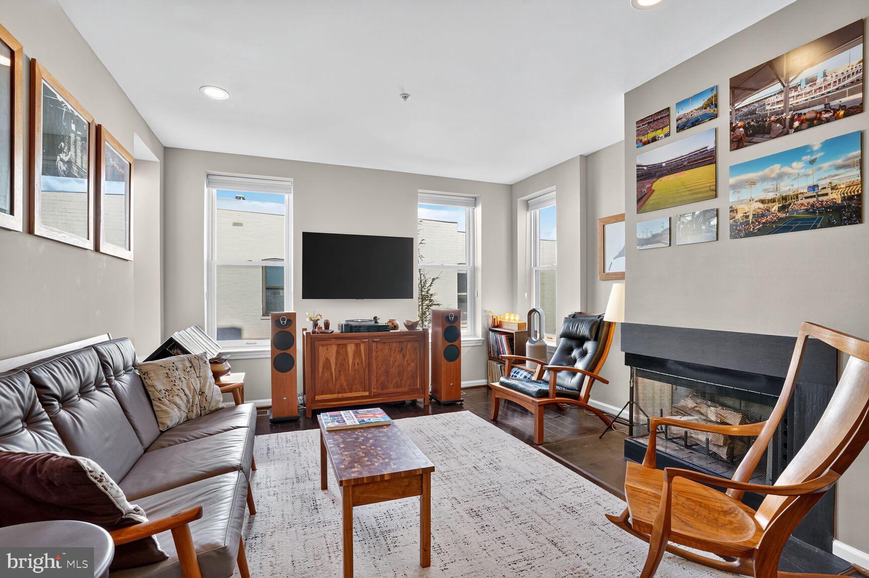 2627 Adams Mill Road Northwest, Unit 403 Washington, DC 20009 - Photo 6 of 38 a living room with furniture and a flat screen tv