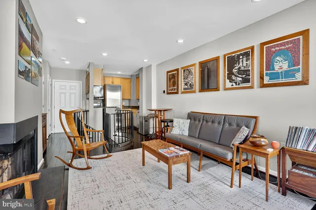 a living room with furniture a rug and a flat screen tv