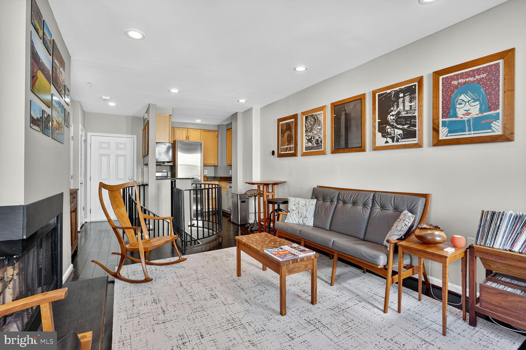2627 Adams Mill Road Northwest, Unit 403 Washington, DC 20009 - Photo 8 of 38 a living room with furniture a rug and a flat screen tv