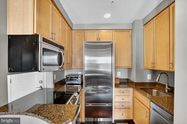a kitchen with a refrigerator microwave and stove