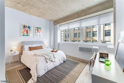 a bedroom with a bed and a large window