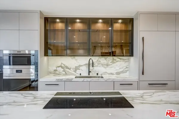 a kitchen with a sink and a refrigerator