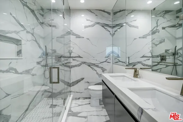 a bathroom with a sink vanity granite and toilet