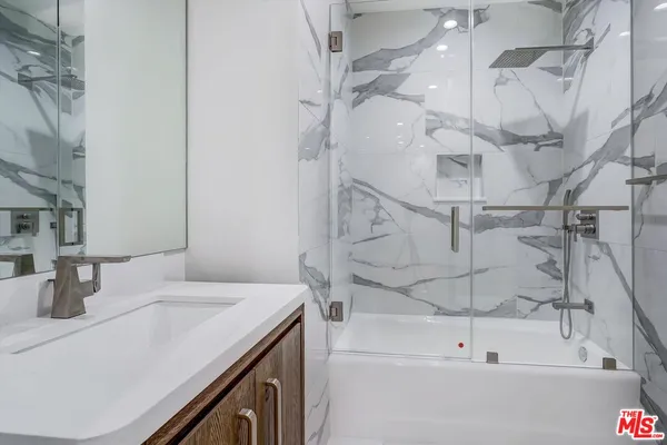 a bathroom with a bathtub and shower